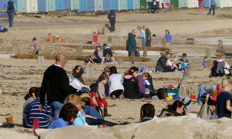 Beachgoers enjoy the unseasonably warm late October weather ion Avon beach in Christchurch, n Dorset