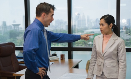 man shouting at a woman and pointing his finger at her