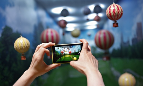 A woman takes a picture with her smartphone