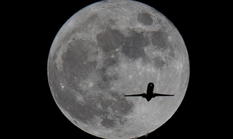 Plane in front of the moon