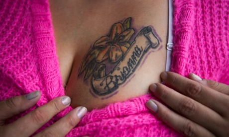 Andrea Cathey, a human trafficking survivor, shows off her tattoo.