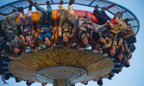 People enjoy a ride during the Eid al-Fitr holiday at a park in Rawalpindi, Pakistan, Wednesday, July 30, 2014.