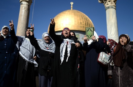 Women shout slogans in front of the Al Aqsa Mosque, where Israel restricts entry of Palestinians under 35, after Friday prayer