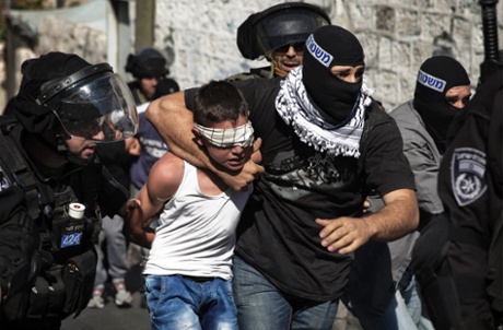 Israeli police detain a Palestinian youth following clashes after Friday prayers in the East Jerusalem neighbourhood of Wadi al-Joz