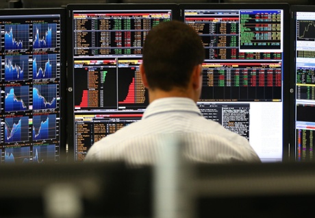 An employee views trading screens.