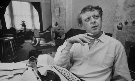 Author Anthony Burgess smoking a cigar at his home, 1968.