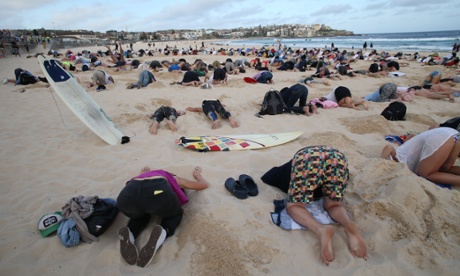 More than 400 people buried their heads in the sand at Sydney's Bondi Beach. Photograph: Mike Bowers