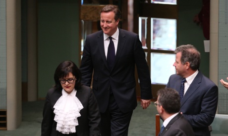 UK Prime Minister David Cameron is led into the chamber by the Usher of the Black Rod.