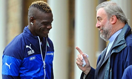 Italy forward Mario Balotelli talks with priest Don Massimiliano during his team's training session in Florence.
