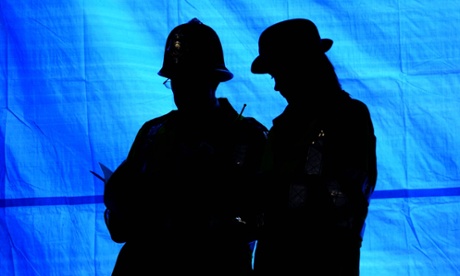 Police officers stand outside a cordoned off area in Camden, North London.
