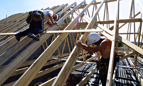 Construction workers building a roof. Photograph: Frank Baron for the Guardian
