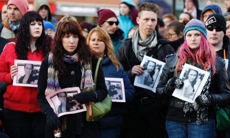 People hold photographs of 17-year-old Rehtaeh Parsons during a memorial vigil at Victoria Park in Halifax, Nova Scotia, 11 April 2013.