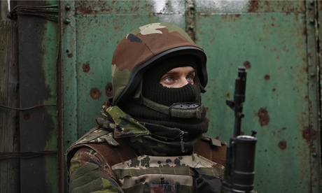 Ukrainian volunteer fighter stands guard in Peski near Donetsk