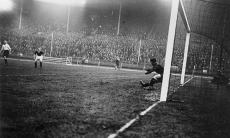 England's goalkeeper, Ted Hufton, dives in a vain attempt to stop an Alex Jackson shot during Scotland's 5-1 win at Wembley in 1928.