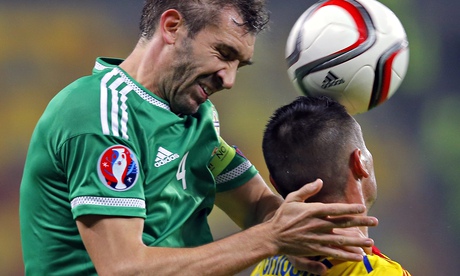 Northern Ireland's Gareth McAuley and Romania's Dragos Gragore