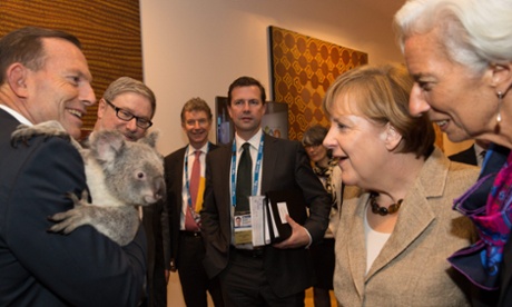 Australian Prime Minister Tony Abbott (L), German Chancellor Angela Merkel (2-R) and Managing Director of the International Monetary Fund (IMF) Christine Lagarde meet a koala bear before the start of the first G20 meeting in Brisbane, Australia, 15 November 2014.