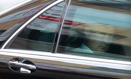 Russian President Vladimir Putin looks out from his limousine en route to Brisbane Airport as he leaves the G20 leaders summit early, November 16, 2014.