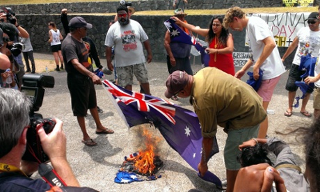 Indigenous rights protesters burn Australian national flags during a rally on the sidelines of the G20 summit in Brisbane, Australia 16 November 2014.