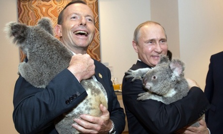 This handout photograph taken on November 15, 2014, and released by Australia G20 show s Australia's Prime Minister Tony Abbott (L) and Russia's President Vladimir Putin as they meet Koalas before the start of the first G20 meeting in Brisbane.