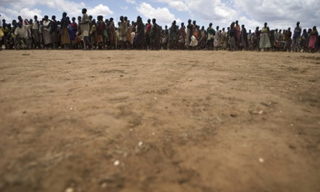 People wait in line during a food distribution at Morulinga, Moroto.