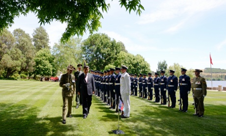 Chinese President Xi Jinping receives a ceremonial welcome on the lawns of Government House