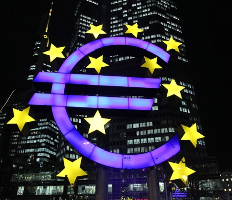 An illuminated EURO sign in front of the European Central Bank.