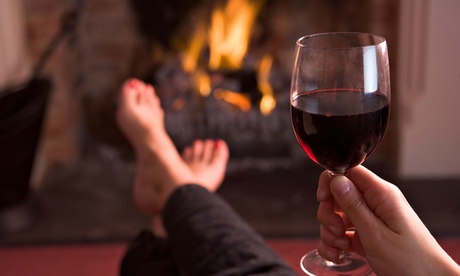 A woman drinking a glass of wine at home