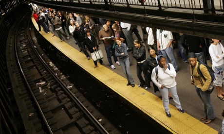 Subway riders wait for a train on the platform at Union Square station October 9, 2005 in New York City.