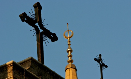 Mosque's minaret and cathedral's crosses