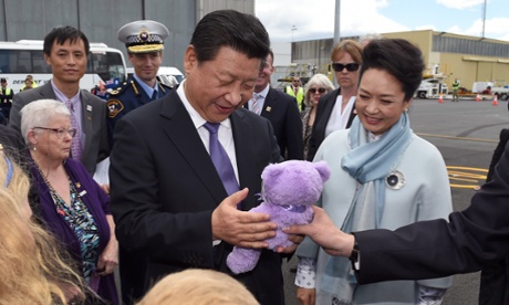 Chinese President Xi Jinping (C) and his wife Madame Peng Liyuan (R) are presented with a Lavender Bear as they arrive in Hobart, Tuesday, Nov. 18, 2014. President Jinping is in Hobart following the G20 leaders summit in Brisbane, and will meet local school students and planted a tree at Government House.