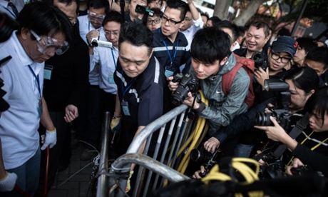 A security staff member removes a barricade outside the Citic tower in the Admiralty district of Hong Kong.
