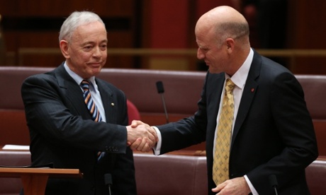 South Australian family first senator Bob Day is congratulated by  Senator David Leyonhjelm.