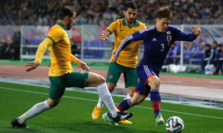 Gotoku Sakai of Japan fights for the ball against Australia's James Troisi, left.