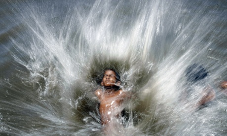 A child somersaults into the the Arabian Sea to beat the afternoon heat in Mumbai
