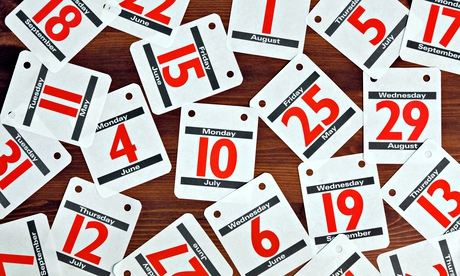 Calendar dates spread out on a wooden desk