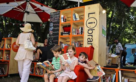 Children read books at the Lawn Library at Festival Village, Sydney
