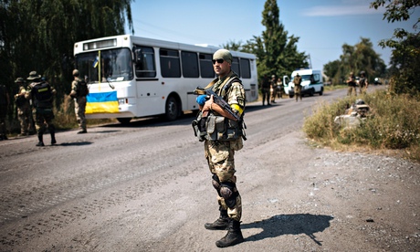 A Ukrainian soldier stands guard in Maryinka, near Donetsk, Ukraine