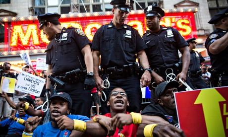 Fast-food workers demanding higher wages and unionisation block traffic near Times Square, NYC