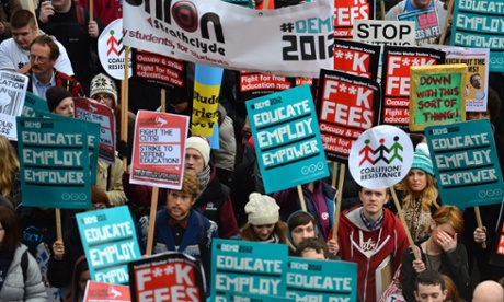 students holding placards at a march against cuts tuition fees and unemployment