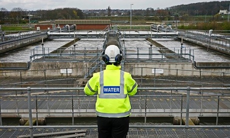 A worker looks over treatment tanks at a Severn Trent sewage works in Nottinghamshire