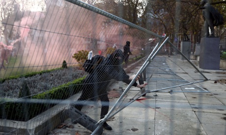 Protesters pull barriers apart in Parliament Square during a demonstration against fees.