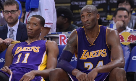 Los Angeles Lakers Wesley Johnson and Kobe Bryant watch on as their season begins on the worst possible note