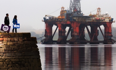 A yes campaigner and no campaigner during the Scottish independence referendum, at Cromarty Firth in the Scottish Highlands, with a drilling platform towering over them.