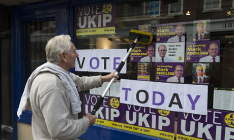 A Ukip supporter cleaning the windows of the Rochester campaign office.