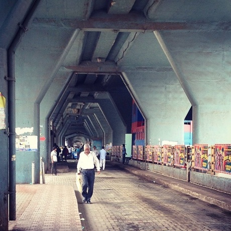 A man walks below the Dadar TT flyover.