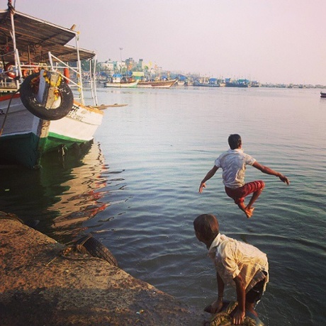 Fishermen boys jump off the wharf at Madh.