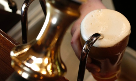 A barman pulls a pint of beer in a pub in Liverpool