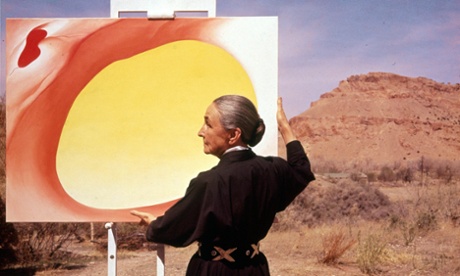 Georgia O'Keeffe adjusts a canvas from her Pelvis Series - Red With Yellow, in Albuquerque, New Mexico, in 1960.