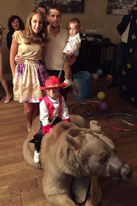 Kombarov's son rides the bear in this now-deleted picture.