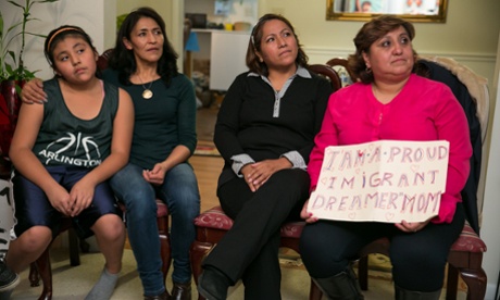The Andrade and Vaca families watching President Obama addressing the country.